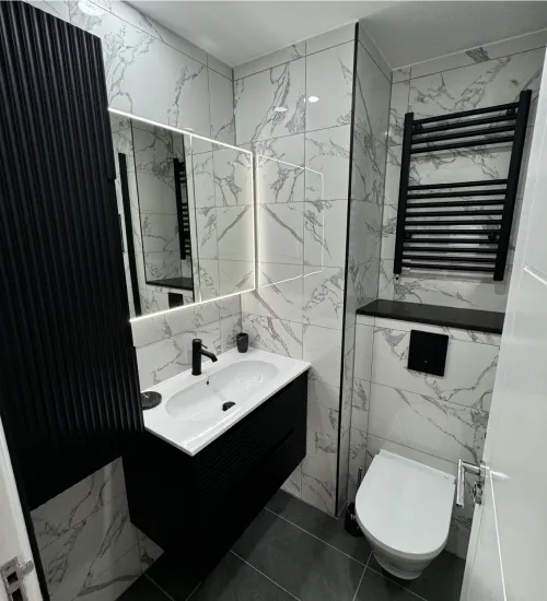 Chrome fixtures and tile finishes in newly fitted bathroom