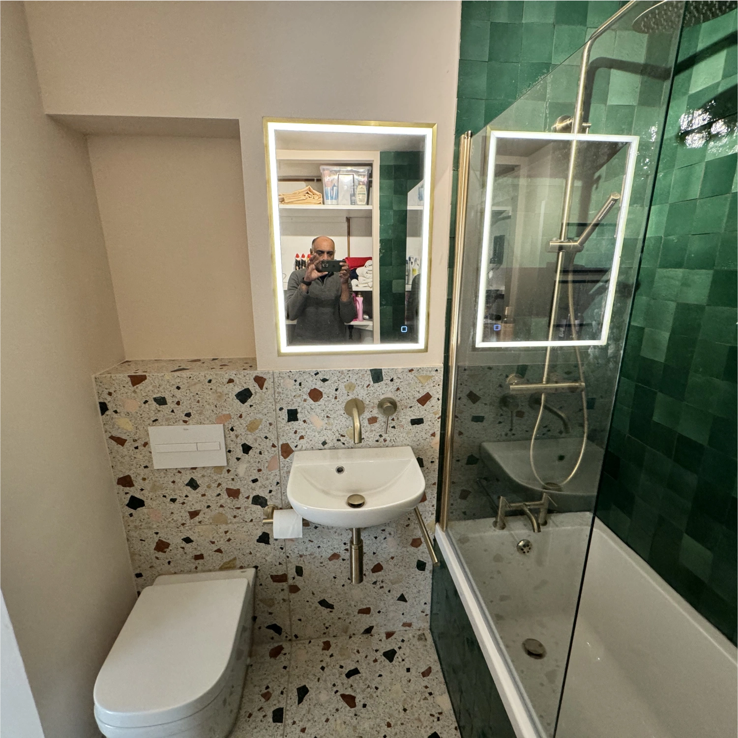 Fully fitted bathroom with freestanding bath and mirror