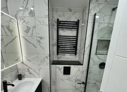 Finished bathroom showing tile patterns and shower