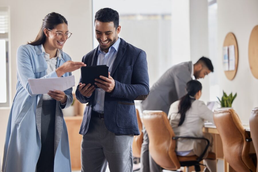 Theres our solution. Shot of two businesspeople having a conversation in an office.